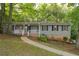 Charming one-story home featuring a welcoming front porch and professionally landscaped front yard at 3521 Brookhill Cir, Marietta, GA 30062