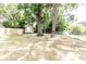 A large backyard featuring mature trees, a small storage shed, and wood and chain-link fencing at 8316 Grady St, Douglasville, GA 30134