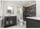 Modern bathroom with a dark granite shower, stylish vanity and contemporary fixtures at 8316 Grady St, Douglasville, GA 30134
