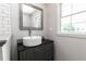 Bathroom featuring gray vanity with black countertop and a vessel sink at 8316 Grady St, Douglasville, GA 30134