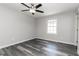 Bedroom featuring wood-look floors, a ceiling fan, and bright, natural light at 8316 Grady St, Douglasville, GA 30134