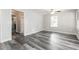 Bright bedroom features modern ceiling fan, light gray walls, and durable, wood-look floors at 8316 Grady St, Douglasville, GA 30134