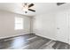 Bedroom featuring wood-look floors, overhead ceiling fan, and neutral color scheme at 8316 Grady St, Douglasville, GA 30134