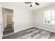 Bedroom features wood floors, neutral walls, ceiling fan and a large window for natural light at 8316 Grady St, Douglasville, GA 30134
