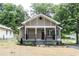 Charming single-story home with a welcoming front porch and well-manicured lawn at 8316 Grady St, Douglasville, GA 30134