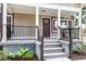 Inviting front porch with craftsman style railings, posts, and stylish front door at 8316 Grady St, Douglasville, GA 30134