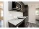 Kitchen features granite countertops, dark cabinets, stainless microwave and stylish backsplash at 8316 Grady St, Douglasville, GA 30134