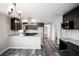 Open-concept kitchen with stainless steel appliances, granite countertops, and modern finishes at 8316 Grady St, Douglasville, GA 30134