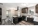 Modern kitchen featuring stainless steel appliances, granite countertops, and dark cabinets at 8316 Grady St, Douglasville, GA 30134
