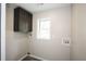 The laundry room features gray cabinets and a window allowing for natural light at 8316 Grady St, Douglasville, GA 30134