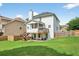 Expansive backyard featuring a well-maintained lawn, multi-level deck, and mature trees at 910 Pebble Creek Trl, Suwanee, GA 30024