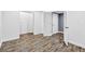 Basement with wood-look flooring and multiple white doors at 910 Pebble Creek Trl, Suwanee, GA 30024