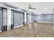 Large basement area featuring wood-look floors, ceiling fans, and natural light at 910 Pebble Creek Trl, Suwanee, GA 30024