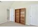 Bedroom featuring carpet flooring, a built-in bookshelf, and white doors at 910 Pebble Creek Trl, Suwanee, GA 30024