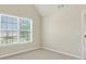 Empty bedroom with neutral carpet and a window at 910 Pebble Creek Trl, Suwanee, GA 30024