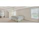 Bright bedroom offering a tray ceiling, large windows, and an adjoining bathroom at 910 Pebble Creek Trl, Suwanee, GA 30024
