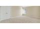 Spacious empty bedroom with carpet, double doors, and a window at 910 Pebble Creek Trl, Suwanee, GA 30024