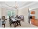Formal dining room with tray ceilings, hardwood floors, and access to the kitchen at 910 Pebble Creek Trl, Suwanee, GA 30024