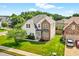 Charming two-story home featuring a well-manicured lawn, stone accents, and lush landscaping at 910 Pebble Creek Trl, Suwanee, GA 30024