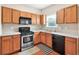 Well-lit kitchen with stainless steel appliances, light wood cabinetry, and modern finishes at 910 Pebble Creek Trl, Suwanee, GA 30024