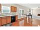 Efficient kitchen layout with hardwood floors, black appliances, and ample counter space at 910 Pebble Creek Trl, Suwanee, GA 30024