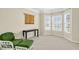 Bright living room featuring neutral carpet, large windows, and a chair with a table at 910 Pebble Creek Trl, Suwanee, GA 30024