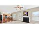 Open-concept living area with hardwood floors, a fireplace, and adjacent kitchen at 910 Pebble Creek Trl, Suwanee, GA 30024