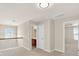 Spacious loft featuring natural lighting, a unique window, and access to an adjacent bathroom and bedroom at 910 Pebble Creek Trl, Suwanee, GA 30024