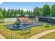 Community playground featuring climbing structures, slides, and a cushioned play surface at 910 Pebble Creek Trl, Suwanee, GA 30024