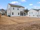 Picture of the rear of the home showing the enclosed patio, expansive lawn, and siding at 2456 Hidden Creek Rd, Kennesaw, GA 30152