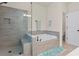 Bathroom featuring tile shower, soaking tub and commode at 2456 Hidden Creek Rd, Kennesaw, GA 30152