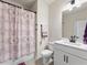 Bathroom with tub shower combo, patterned curtain, and modern vanity at 2456 Hidden Creek Rd, Kennesaw, GA 30152