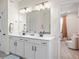 Bathroom featuring double sink vanity, and view of an adjoining bedroom at 2456 Hidden Creek Rd, Kennesaw, GA 30152