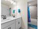 Bright bathroom features double sinks with matte black fixtures and a shower/tub combo with blue accent towels at 2456 Hidden Creek Rd, Kennesaw, GA 30152