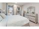 Comfortable bedroom with ample natural light, neutral decor, and a mirrored dresser at 2456 Hidden Creek Rd, Kennesaw, GA 30152
