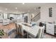 Elegant dining room with a large table, staircase access, and an open view into the kitchen and living area at 2456 Hidden Creek Rd, Kennesaw, GA 30152