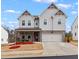 Charming two-story home featuring a large two-car garage and appealing architectural details at 2456 Hidden Creek Rd, Kennesaw, GA 30152