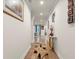 Long, bright hallway with hardwood floors and decorative wall art at 2456 Hidden Creek Rd, Kennesaw, GA 30152