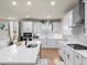 Bright kitchen featuring an island with a sink, white cabinets, and stainless steel appliances at 2456 Hidden Creek Rd, Kennesaw, GA 30152