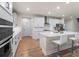 Contemporary kitchen boasts white cabinets, a large island, and stainless steel appliances at 2456 Hidden Creek Rd, Kennesaw, GA 30152