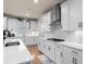Well-equipped kitchen features white cabinetry, quartz countertops, and modern appliances at 2456 Hidden Creek Rd, Kennesaw, GA 30152