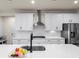 Modern kitchen with white cabinets, stainless steel appliances, and a quartz countertop island at 2456 Hidden Creek Rd, Kennesaw, GA 30152