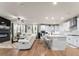Open-concept living room showcasing a fireplace, white sofas, and an adjacent kitchen area at 2456 Hidden Creek Rd, Kennesaw, GA 30152
