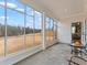 Enclosed patio with full views of backyard, features a table, chairs and access to the lawn at 2456 Hidden Creek Rd, Kennesaw, GA 30152