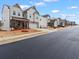 Inviting street view showcases the charming community featuring newly built homes with well-manicured lawns at 2456 Hidden Creek Rd, Kennesaw, GA 30152