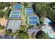 Aerial view of tennis courts and a pool surrounded by lush landscaping at 3028 Towneside Ln, Woodstock, GA 30189