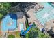 Overhead shot of pool area offering a water slide, baby pool, main pool and beautiful mature trees and seating at 3028 Towneside Ln, Woodstock, GA 30189