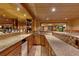 Basement bar featuring granite countertops, wooden cabinetry, wine storage, sink, and mini fridge at 3028 Towneside Ln, Woodstock, GA 30189