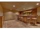 Finished basement wet bar with wood paneling, seating for eight, tile flooring and recessed lighting at 3028 Towneside Ln, Woodstock, GA 30189