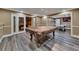 Finished basement featuring pool table, game area, luxury vinyl plank flooring, and neutral paint at 3028 Towneside Ln, Woodstock, GA 30189